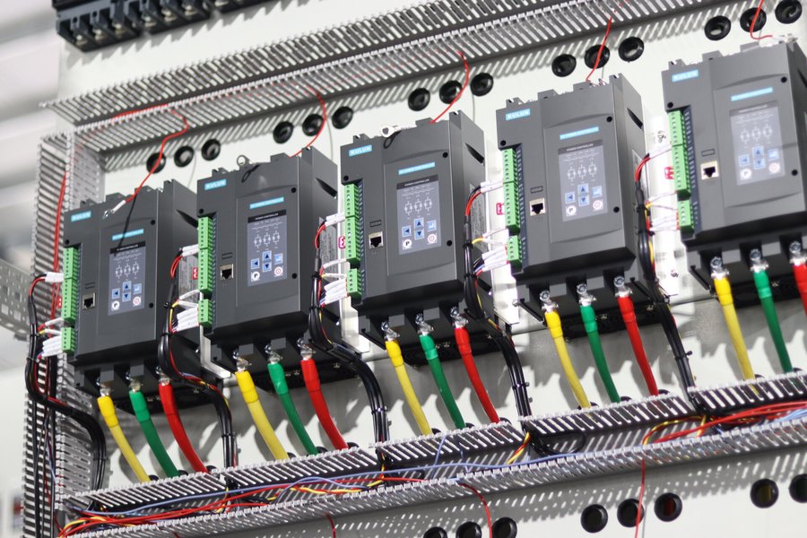 SCR power controllers installed side by side inside a cabinet, three-phase busbars and control wiring connected